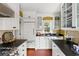 Bright kitchen with white cabinetry, dark countertops, and modern appliances creating a culinary haven at 22 Lamboll St # C, Charleston, SC 29401