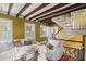 Bright living room with exposed beams, staircase, and elegant decor for a warm atmosphere at 22 Lamboll St # C, Charleston, SC 29401