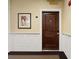 A unit front door with stylish hardware, secure entry, and elegant wainscoting at 2244 Ashley Crossing Dr # 1125, Charleston, SC 29414