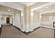 Bright hallway featuring carpeted floors, neutral paint, and decorative wainscoting at 2244 Ashley Crossing Dr # 1125, Charleston, SC 29414