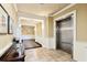 Well-lit hallway with tiled floor, elevator access, and classic architectural details at 2244 Ashley Crossing Dr # 1125, Charleston, SC 29414