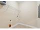 Bright laundry room featuring neutral paint and a wire shelf for storage and tiled flooring at 2244 Ashley Crossing Dr # 1125, Charleston, SC 29414