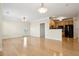Open living area with hardwood floors connecting the kitchen, dining, and access to balcony at 2244 Ashley Crossing Dr # 1125, Charleston, SC 29414
