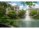 Scenic pond with a fountain, trees, and the apartment buildings in the background at 2244 Ashley Crossing Dr # 1125, Charleston, SC 29414