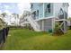 A view of the house and its backyard features a green lawn and a partially covered under-house structure at 2313 Bucktail Ct, Mount Pleasant, SC 29466