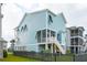 Charming blue two-story home featuring a screened porch, stair access, and manicured lawn, perfect for coastal living at 2313 Bucktail Ct, Mount Pleasant, SC 29466