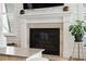 Living room fireplace features white mantel, stone surround, and decorative accents at 2313 Bucktail Ct, Mount Pleasant, SC 29466