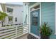 Charming turquoise front door framed by vibrant potted plants and a clean, welcoming entrance at 2313 Bucktail Ct, Mount Pleasant, SC 29466