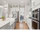 Modern white kitchen with stainless steel appliances and a view into the dining area at 2313 Bucktail Ct, Mount Pleasant, SC 29466