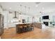 Open concept eat-in kitchen flows into the living area with a fireplace and ceiling fan at 2313 Bucktail Ct, Mount Pleasant, SC 29466