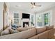 Comfortable living room with a fireplace, TV, ceiling fan and sliding doors to the porch at 2313 Bucktail Ct, Mount Pleasant, SC 29466