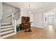 An open-concept living area features staircase and a stylish bar cabinet with wood floors at 2313 Bucktail Ct, Mount Pleasant, SC 29466