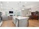 Open floor plan with kitchen island, view to living room and staircase with custom wood display at 2313 Bucktail Ct, Mount Pleasant, SC 29466