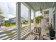 Relaxing porch with classic white columns and cozy seating, capturing a serene view of the peaceful neighborhood at 2313 Bucktail Ct, Mount Pleasant, SC 29466