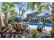 Picturesque backyard pool area with comfortable seating, palm trees, and an umbrella to beat the heat at 2331 Brinkley Rd, Johns Island, SC 29455