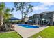 Inviting backyard pool area with lounge seating, umbrellas, and lush landscaping, ideal for outdoor enjoyment at 2331 Brinkley Rd, Johns Island, SC 29455