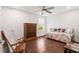 Bright bedroom with hardwood floors, a daybed, and a chest of drawers beneath a sunny window at 2331 Brinkley Rd, Johns Island, SC 29455