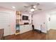 Cozy bonus room with hardwood floors, built-in shelving, a ceiling fan, and a mounted television at 2331 Brinkley Rd, Johns Island, SC 29455