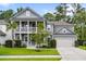 Beautiful two-story home with a double porch, lush green lawn, and a two-car garage at 2331 Brinkley Rd, Johns Island, SC 29455