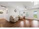 Bright living room featuring hardwood floors, two comfortable leather chairs, and an inviting view of the outdoors at 2331 Brinkley Rd, Johns Island, SC 29455