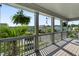 Inviting covered porch with hanging plants, string lights, and scenic neighborhood views from the wooden porch at 2331 Brinkley Rd, Johns Island, SC 29455