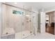 Modern walk-in shower featuring marble tile, glass door, and a bench at 2331 Brinkley Rd, Johns Island, SC 29455
