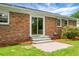 Brick house with a back patio accessible through sliding glass doors at 2456 Lantern St, Charleston, SC 29414