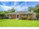 Well-maintained lawn and landscape in backyard, featuring brick exterior at 2456 Lantern St, Charleston, SC 29414