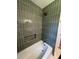 Modern bathroom with stylish vertical tile, a bathtub, and bronze hardware at 2456 Lantern St, Charleston, SC 29414