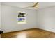 Well-lit bedroom with wood floors, large window overlooking the yard and white trim at 2456 Lantern St, Charleston, SC 29414