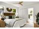 Bright bedroom with a ceiling fan, closet, large bed, and view to the bathroom at 2456 Lantern St, Charleston, SC 29414