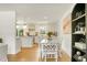 Open-concept dining area with white furniture, seamlessly connected to the modern kitchen at 2456 Lantern St, Charleston, SC 29414