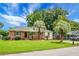 Charming brick house featuring a well-maintained lawn and tropical palm trees at 2456 Lantern St, Charleston, SC 29414
