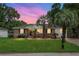 Charming brick home with palm trees, lush lawn, and mature landscaping at 2456 Lantern St, Charleston, SC 29414