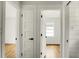 Hallway featuring white paneled doors and views into bedrooms at 2456 Lantern St, Charleston, SC 29414