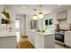 Bright kitchen with an island, white cabinets, stainless appliances, and hardwood floors at 2456 Lantern St, Charleston, SC 29414