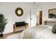 Bright main bedroom with hardwood floors, bench, and round mirror at 2456 Lantern St, Charleston, SC 29414