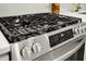 Close-up of a stainless steel stove with black grates and digital display, offering modern cooking features at 2456 Lantern St, Charleston, SC 29414