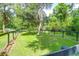 Spacious backyard with green grass, mature trees, and fenced yard at 2494 Cape Rd, Johns Island, SC 29455