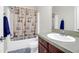 Well-maintained bathroom features a tub with shower, vanity, mirror, and tile flooring at 2494 Cape Rd, Johns Island, SC 29455