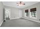 Bedroom featuring carpet, two windows and a ceiling fan, attached to a bathroom at 2494 Cape Rd, Johns Island, SC 29455