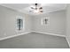 Spacious bedroom with neutral walls, carpet, ceiling fan, and multiple windows allowing natural light at 2494 Cape Rd, Johns Island, SC 29455
