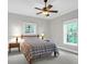 Cozy bedroom featuring neutral walls, carpet, ceiling fan, and windows offering ample natural light at 2494 Cape Rd, Johns Island, SC 29455