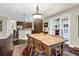Charming dining area featuring hardwood floors, a rustic wood table, and bright natural light from the adjacent kitchen at 2494 Cape Rd, Johns Island, SC 29455