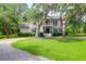 Charming home with a gravel driveway, a front porch, and lovely mature trees at 2494 Cape Rd, Johns Island, SC 29455