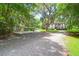 Scenic view of a home with a gravel driveway, a shed, and beautiful mature trees at 2494 Cape Rd, Johns Island, SC 29455