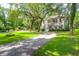 Beautiful home with manicured lawns, mature trees, and a gravel driveway at 2494 Cape Rd, Johns Island, SC 29455