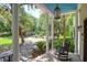 Inviting front porch with columns, rocking chair, and beautiful views at 2494 Cape Rd, Johns Island, SC 29455