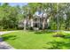Lush green front yard leading to a stately two-story home at 2494 Cape Rd, Johns Island, SC 29455