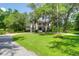 Expansive front yard leading to a stately home, lined with mature trees at 2494 Cape Rd, Johns Island, SC 29455